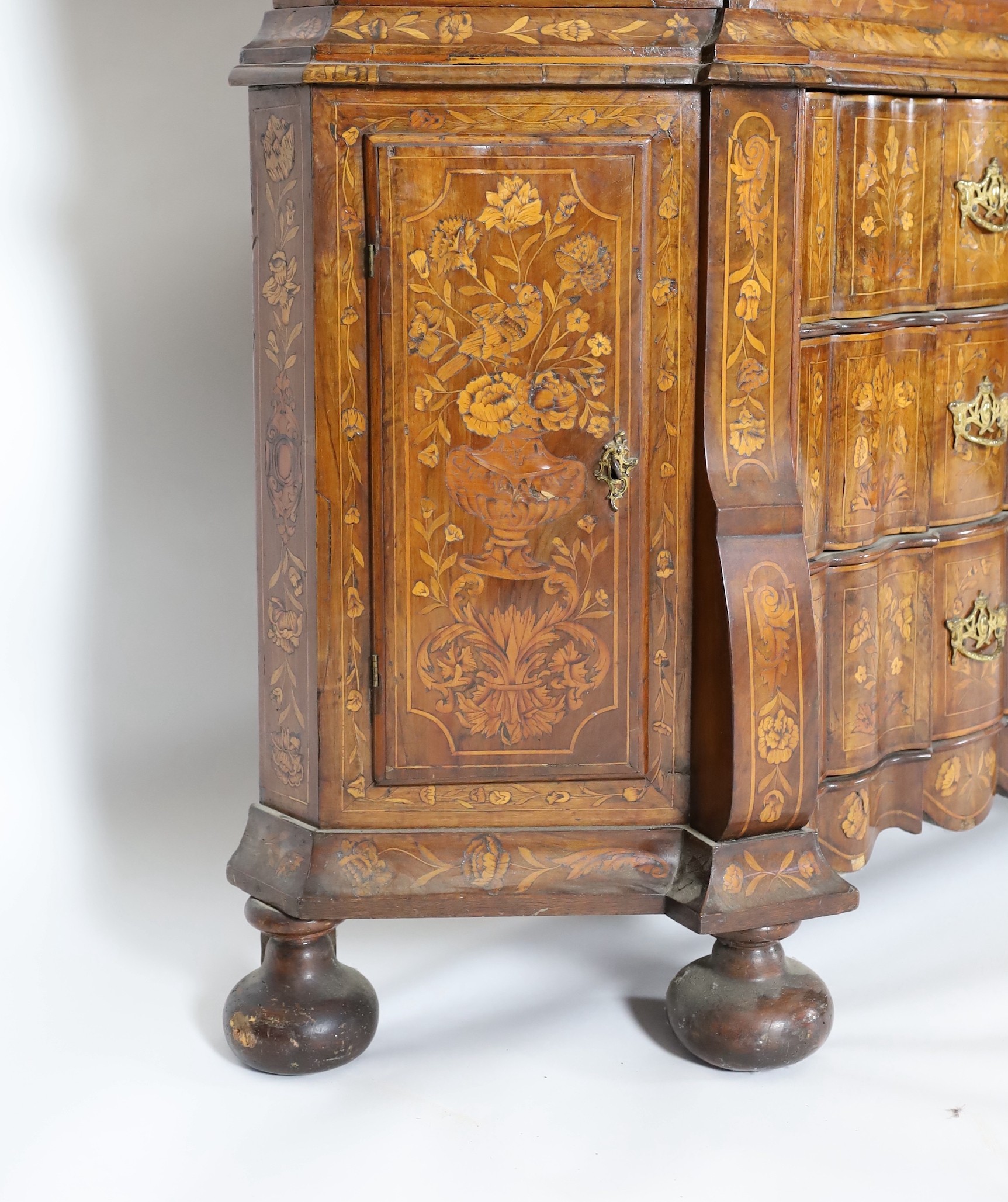 A late 18th century Dutch marquetry inlaid walnut serpentine display cabinet, width 186cm depth 36cm height 260cm